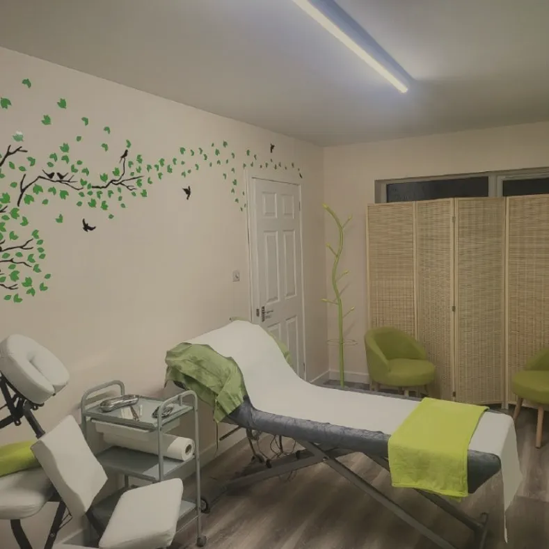 Treatment couch with green blanket